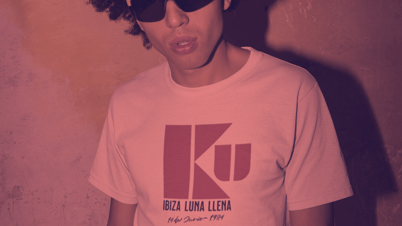NIGHTS. UNDER THE MOON! - A person wearing a KU Ibiza Luna Llena t-shirt, showcasing 1984 nightlife style.