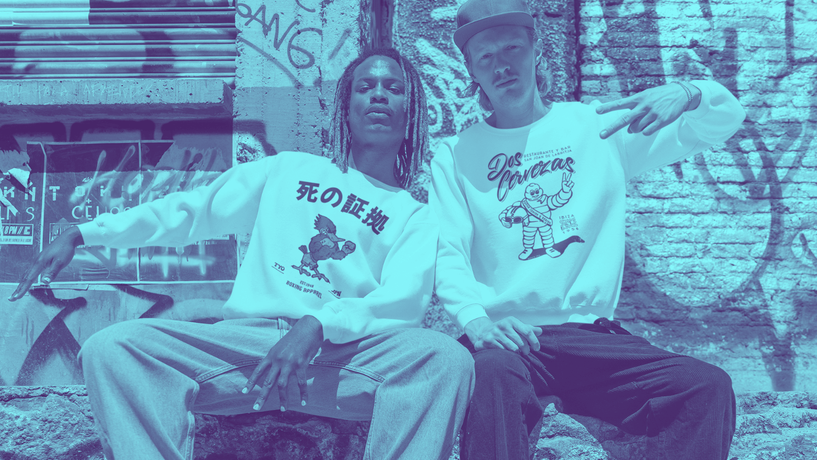 BINKY STORIES. BORN TO BE WORN! Two models showcasing Binky Comfywear sweatshirts in an urban street art setting.