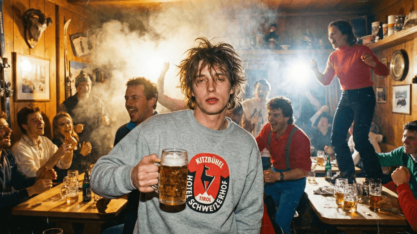 Kitzbühel Après-Ski party atmosphere with people celebrating and enjoying drinks in a lively bar.