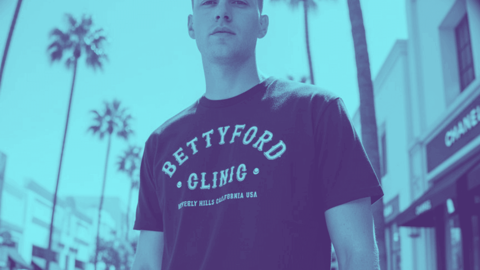 Model wearing a BETTY FORD CLINIC t-shirt in a palm-lined street, showcasing HIGH FASHION. LOW POINTS. LEGENDARY! style.