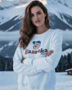 Model wearing BAZOOKA JOE CLUB SWEATER in snowy landscape, featuring retro Bazooka bubble gum design.
