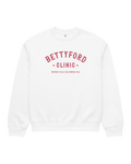 Betty Ford Clinic Heavy Sweater in white, featuring red text, embodying 80s nostalgia and Hollywood culture.