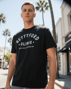 Model wearing BETTY FORD CLINIC VARSITY T-SHIRT in Beverly Hills, showcasing retro style with dark humor.