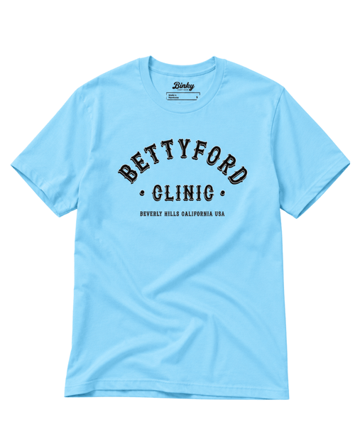 Betty Ford Clinic T-Shirt | Varsity Team in light blue with bold lettering and sporty design.