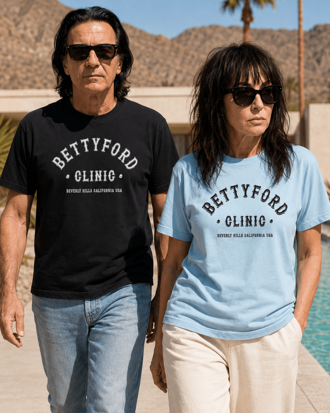 Betty Ford Clinic T-Shirt | Varsity Team worn by couple in stylish outdoor setting, showcasing comfort and retro design.