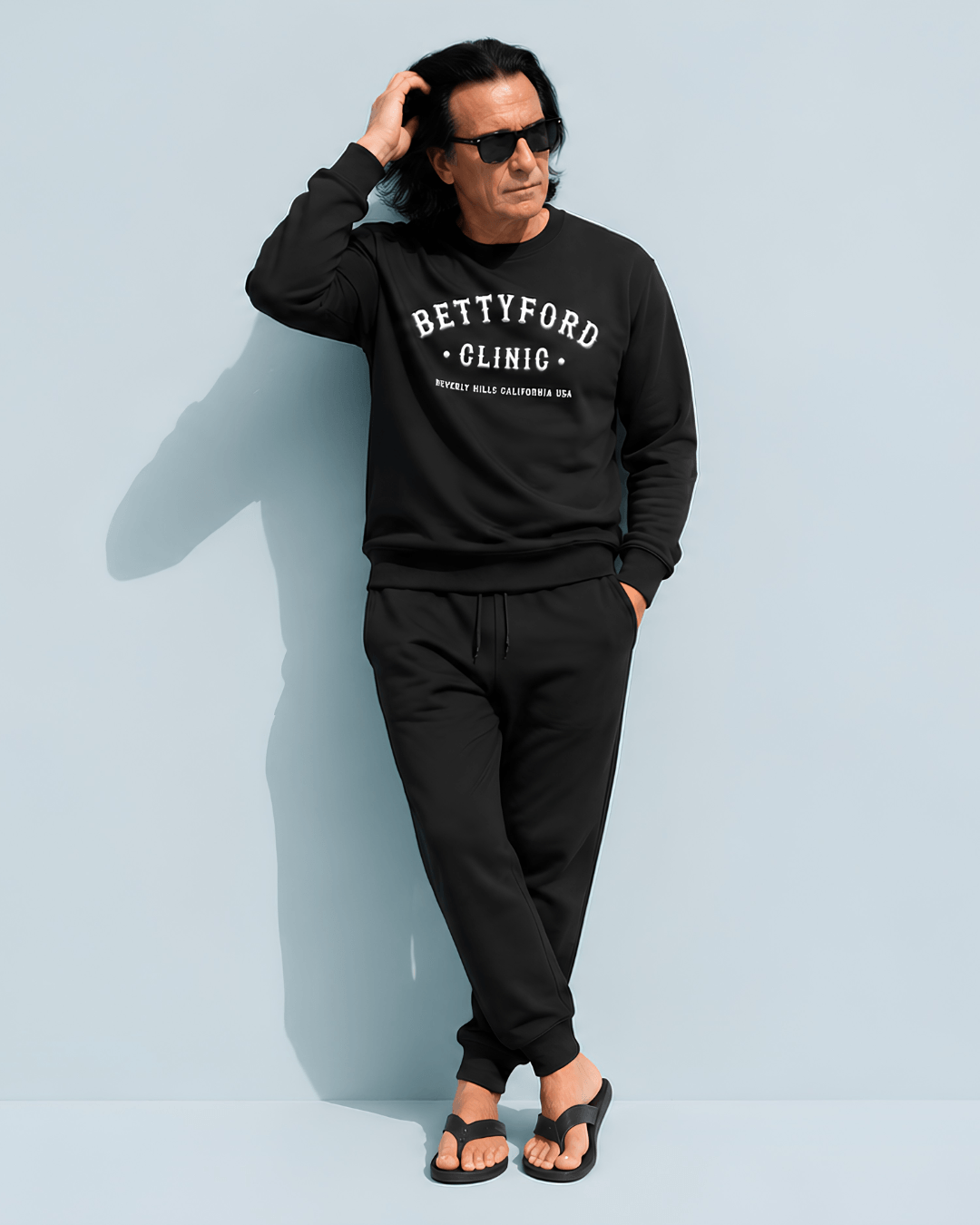 Model wearing a black BETTY FORD CLINIC HEAVY SWEATER with casual pants, showcasing Beverly Hills style.