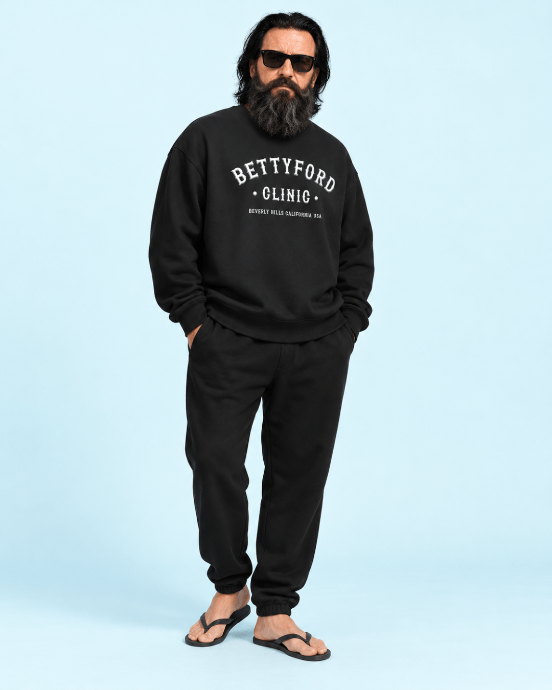 Male model wearing the BINKY Betty Ford Clinic Heavy Sweater in Vintage Black with collegiate front graphic.