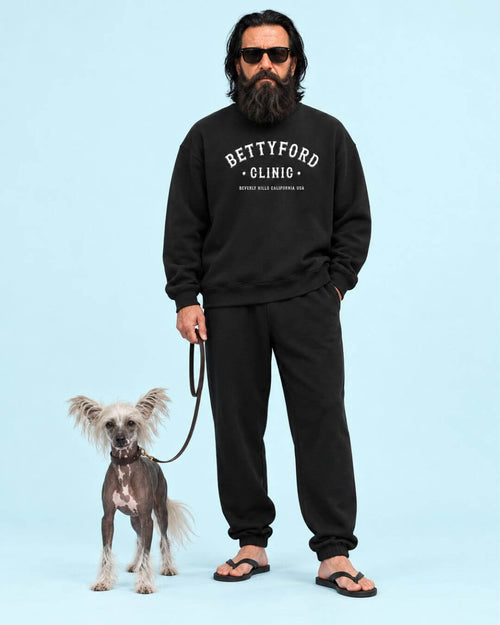 Walter and his dog Curly wearing the BINKY Betty Ford Clinic Heavy Sweater in Vintage Black with collegiate front graphic.