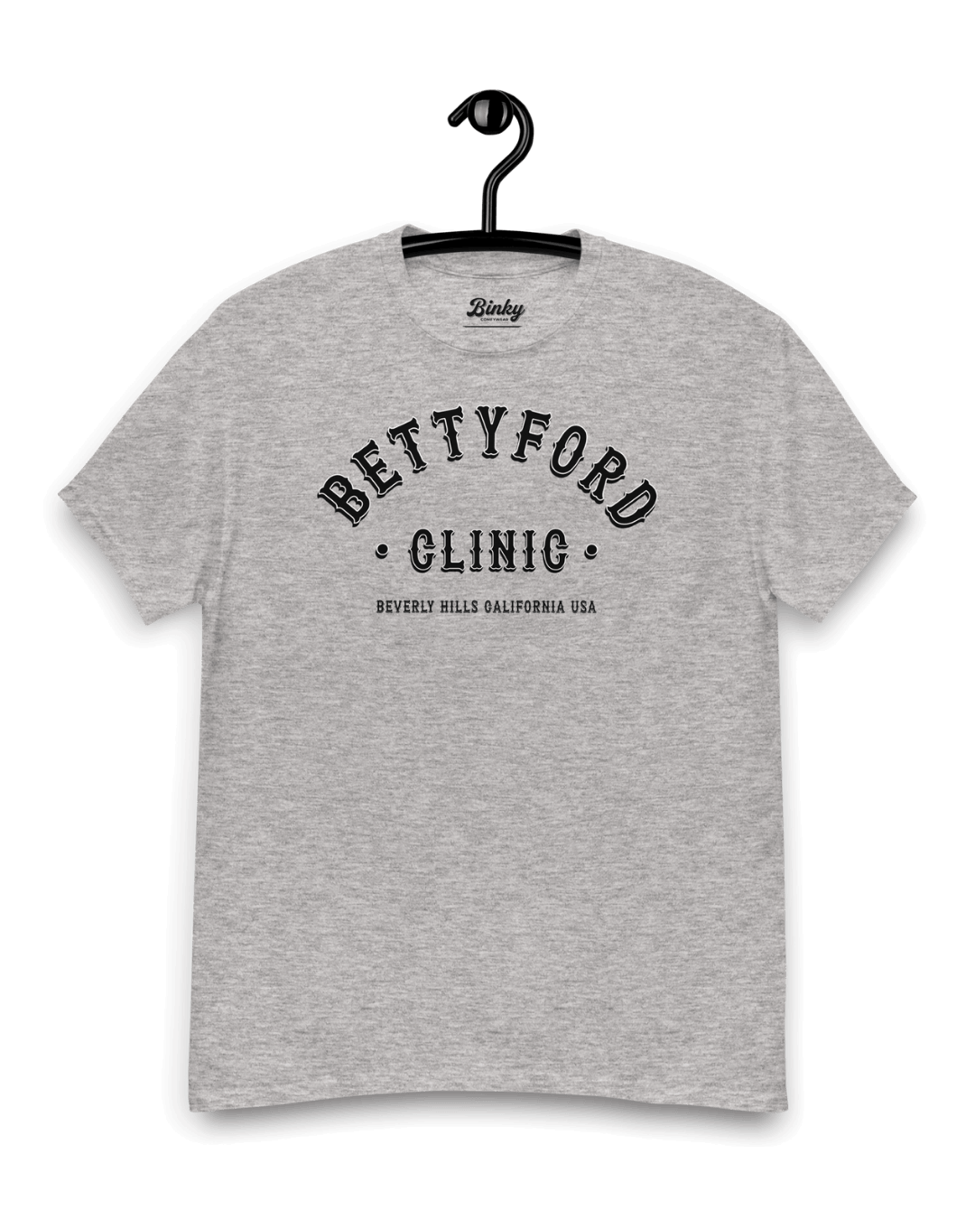 BETTY FORD CLINIC T-SHIRT | VARSITY TEAM, gray T-shirt hanging on a hanger with bold lettering.