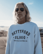 Man wearing a BETTY FORD CLINIC SWEATER in Beverly Hills, showcasing vintage graphic style and casual comfort.