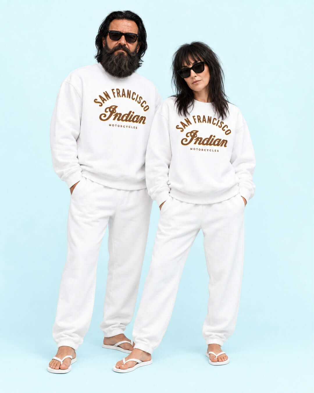 Walter and Helga wearing the White Bay Area Motorcycle Heavy Sweater with matching joggers and flip-flops against the light blue BINKY studio background.