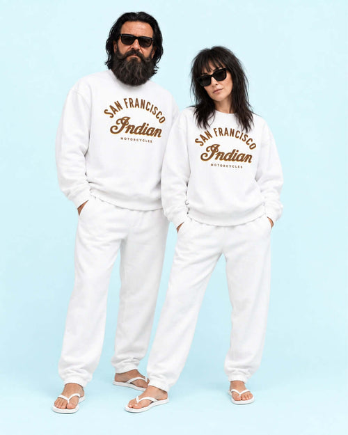 Walter and Helga wearing the White Bay Area Motorcycle Heavy Sweater with matching joggers and flip-flops against the light blue BINKY studio background.