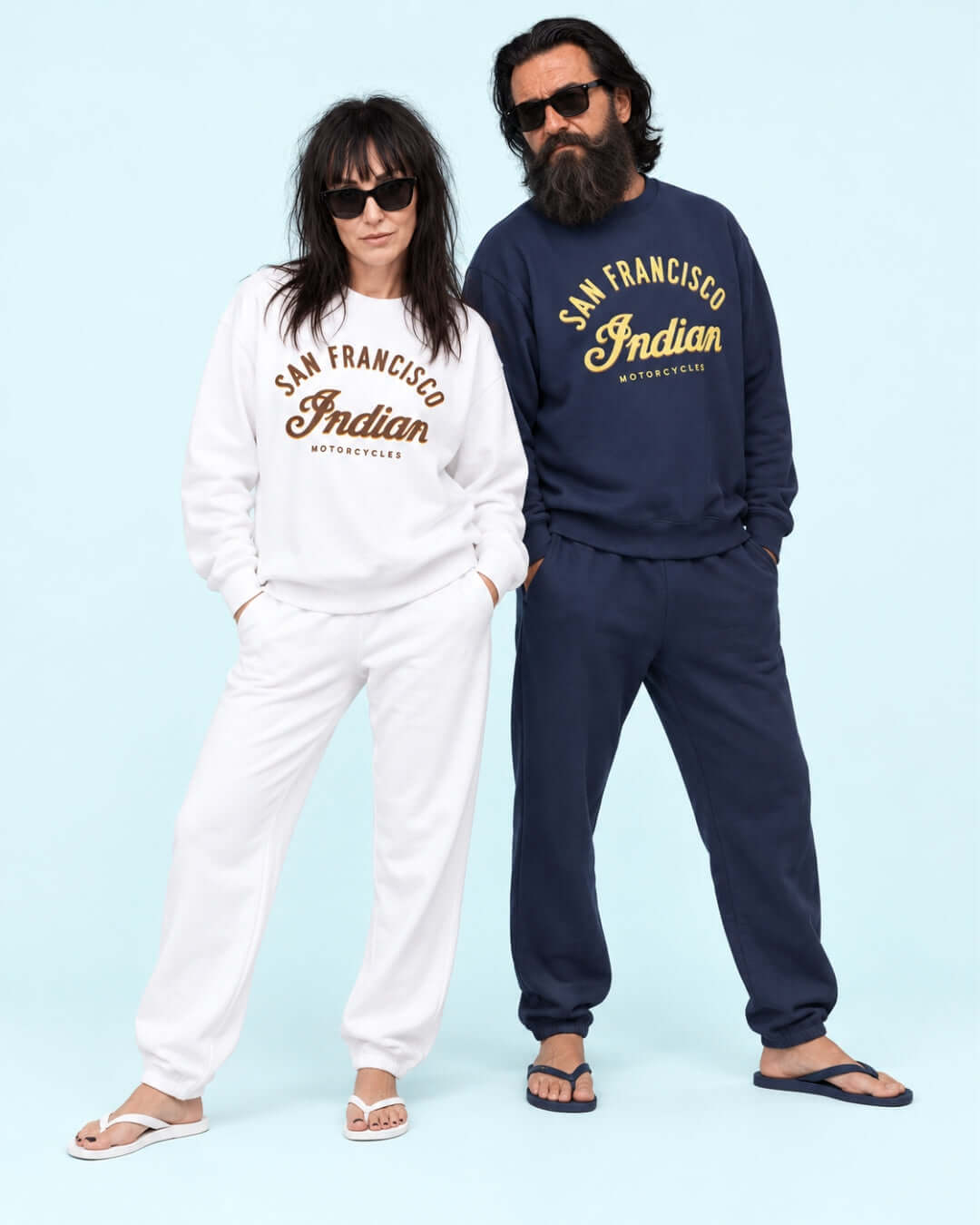 Helga wearing the White Bay Area Motorcycle Heavy Sweater beside Walter in the Navy version, with matching joggers and flip-flops in the BINKY studio.