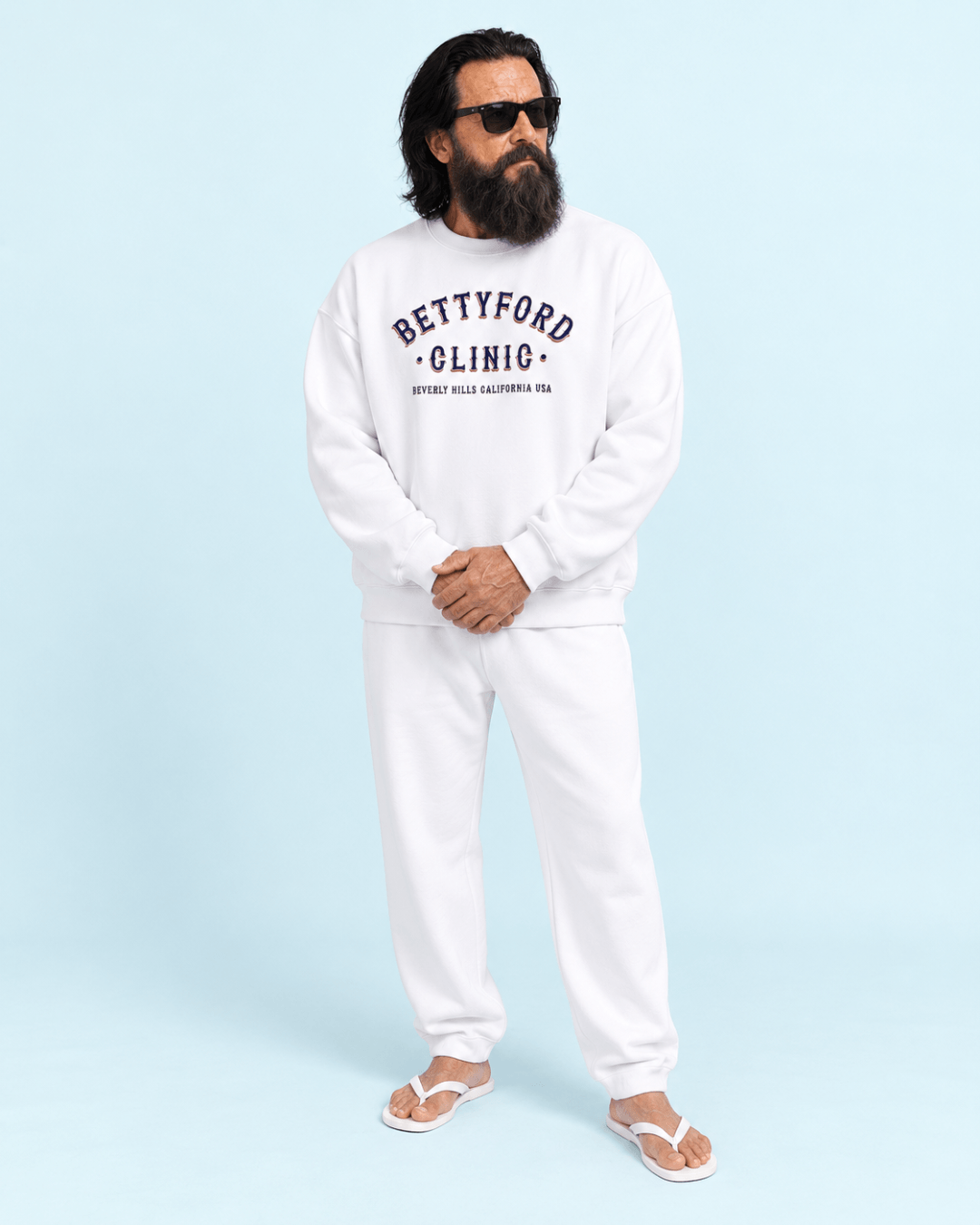 Model wearing the Betty Ford Clinic RWB Heavy Sweater, showcasing classic varsity style in a white setting.