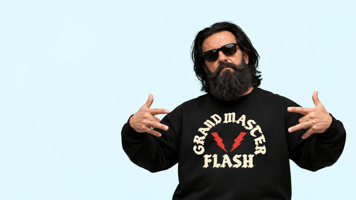 Walter in sunglasses wearing a Binky Comfywear sweatshirt, showcasing 'Grandmaster Flash' design for a stylish flashback look.
