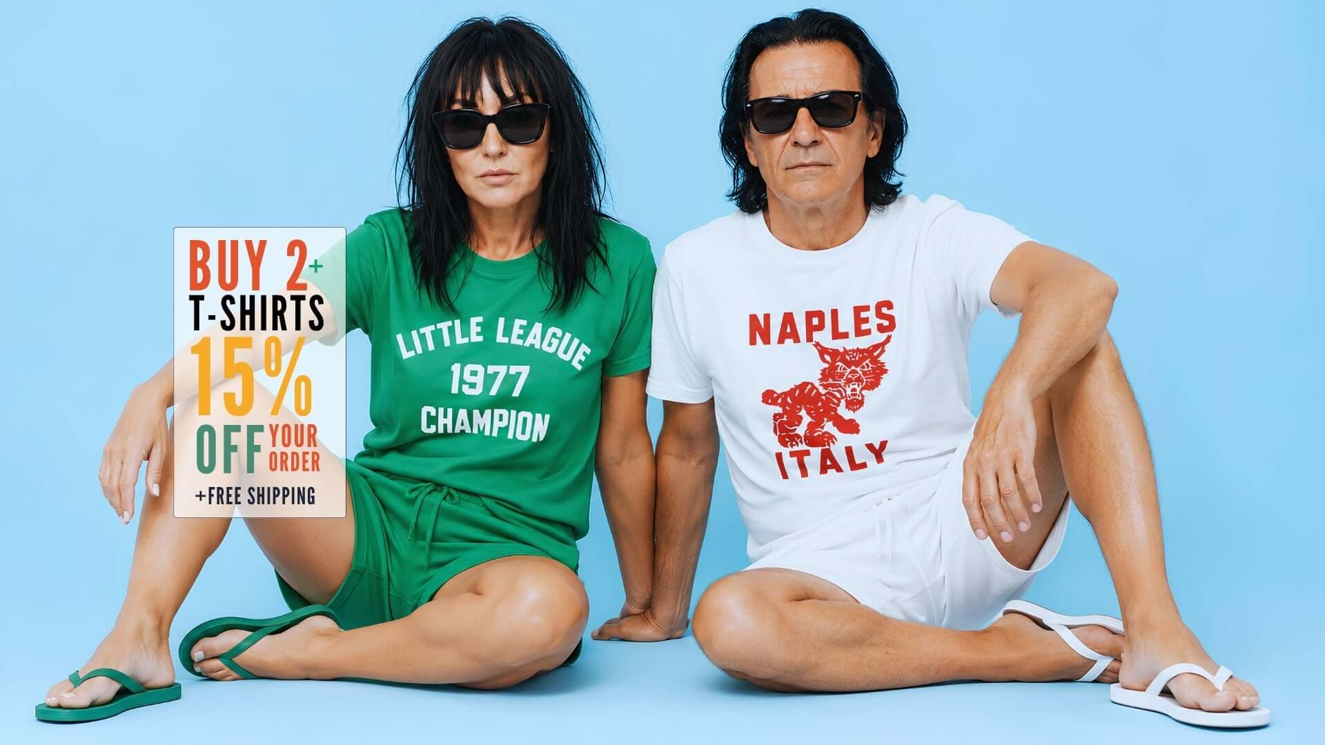 Fashionable couple in graphic tees promoting a sale on T-shirts with a light blue background.