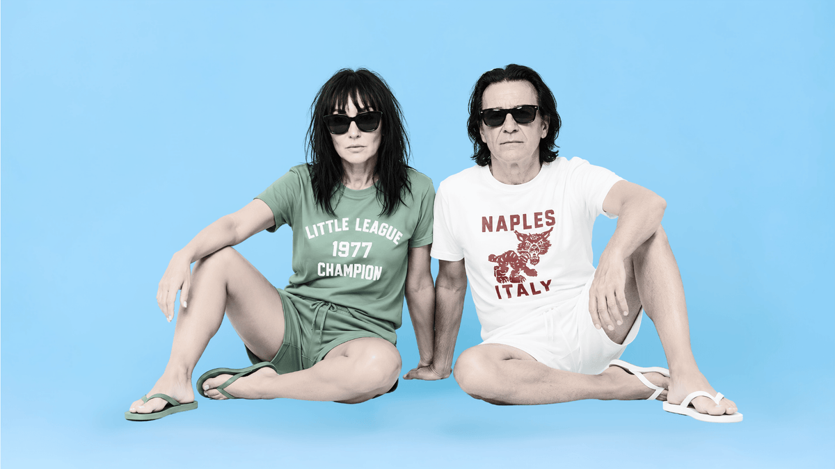 Binky comfywear model couple in stylish shorts, showcasing vintage prints: Little League Champion, Naples Italy.