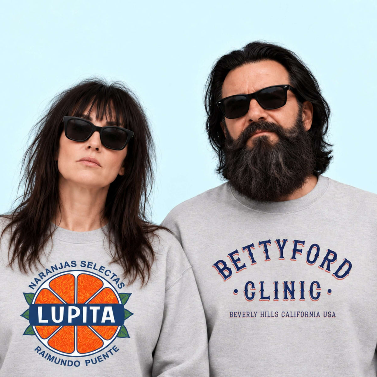 Stylish couple wearing sunglasses and sweatshirts with 'LUPITA' and 'BETTYFORD CLINIC' logos, against a light backdrop.