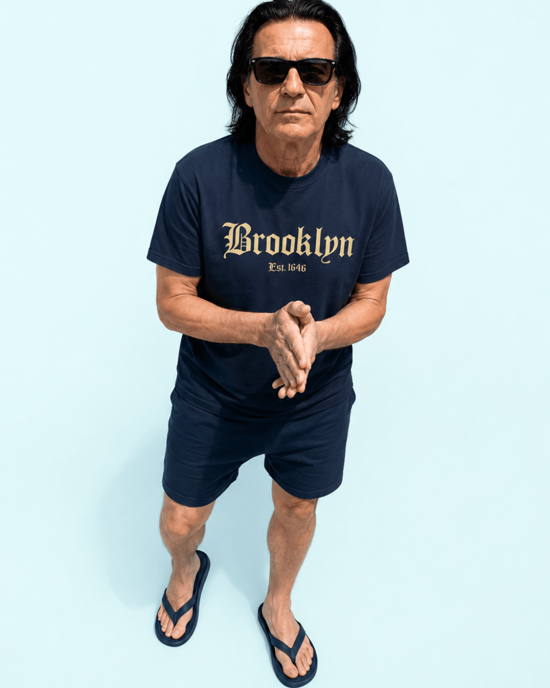 Walter wearing the Navy Brooklyn Est. 1646 T-Shirt with blackletter-style front graphic