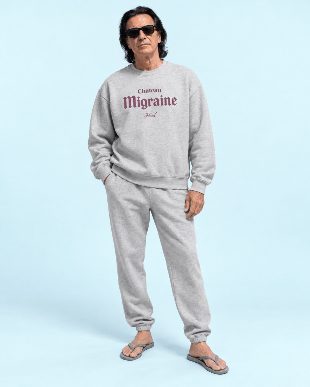 Hotel Migraine Heavy Sweater modeled by a man in gray outfit, perfect for cozy evenings and casual outings.