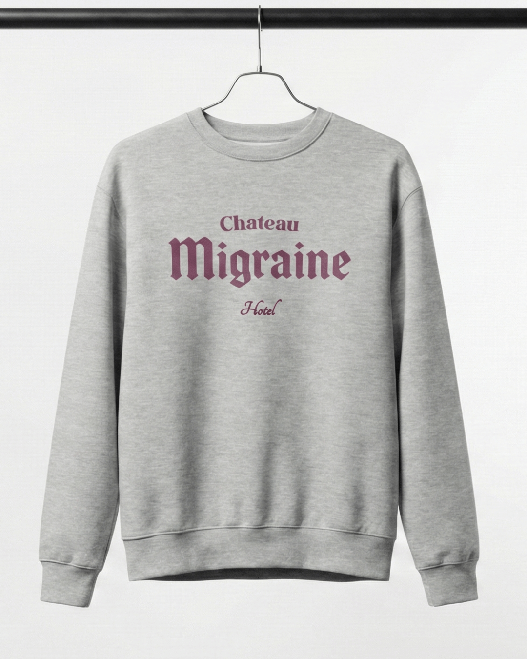 HOTEL MIGRAINE HEAVY SWEATER displayed on a hanger with graphic design in gray.