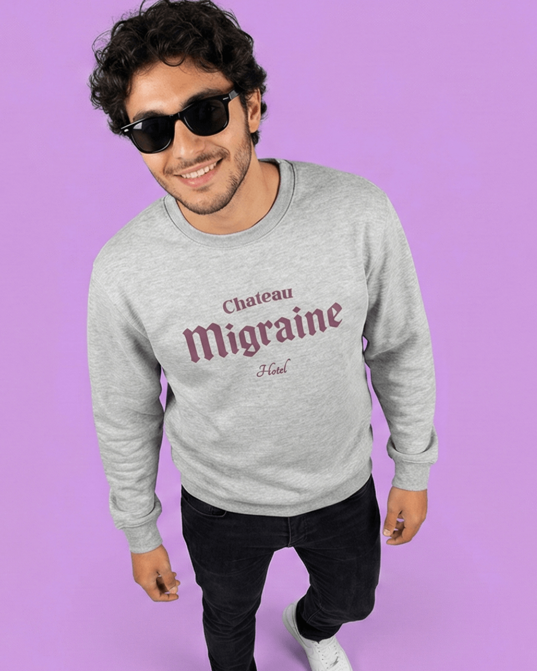 Model wearing a HOTEL MIGRAINE HEAVY SWEATER featuring a graphic design on a purple background.
