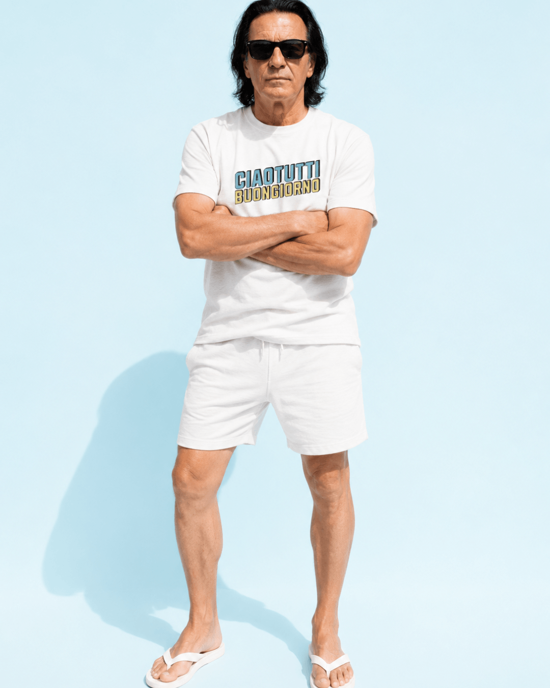 Man wearing Ciao Tutti T-Shirt | Buongiorno Classic with sunglasses against a light blue background.