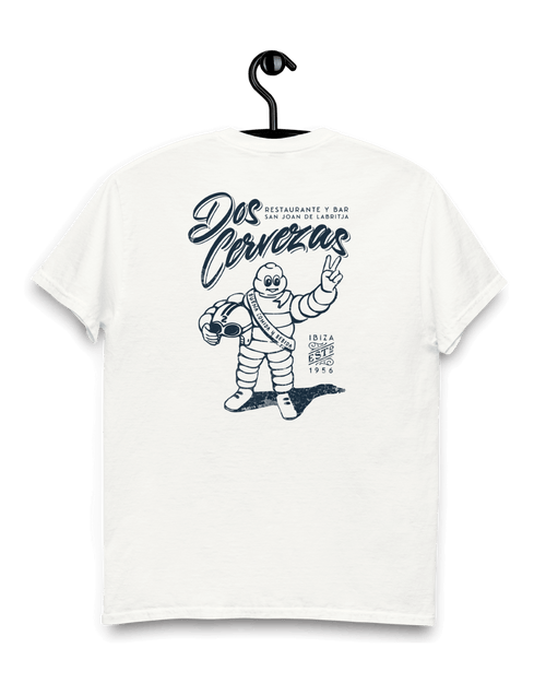 Dos Cervezas T-shirt hanging on a hook, featuring unique graphic print and relaxed fit, perfect for summer wear.