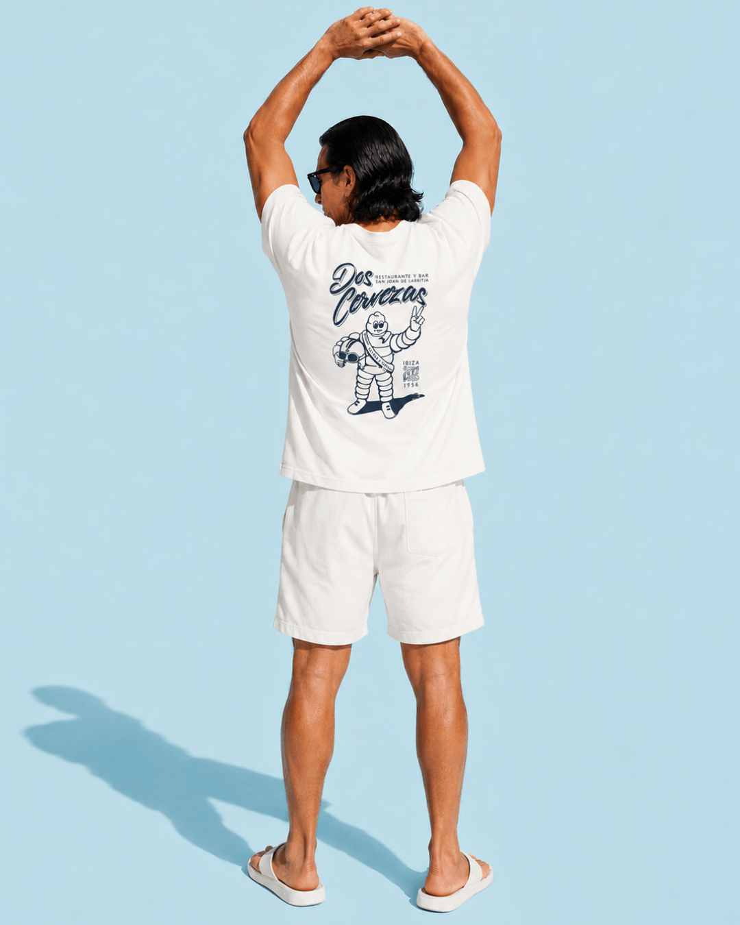 Walter wearing Dos Cervezas T-Shirt | Ibiza Vintage Style in relaxed pose against a blue background.