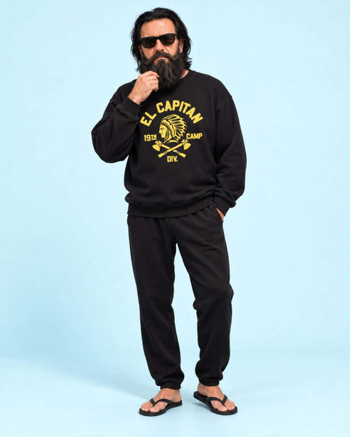 Walter wearing the black BINKY El Capitan Heavy Sweater with yellow graphic