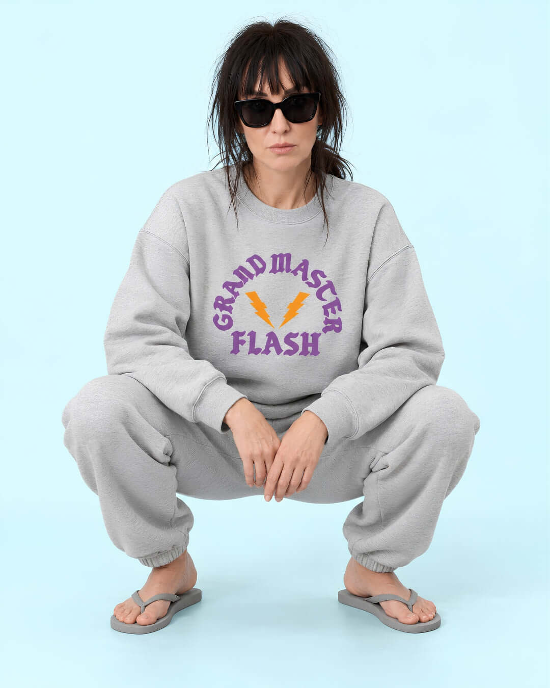 Helga wearing the Athletic Heather BINKY Flashback Heavy Sweater with purple and orange graphic