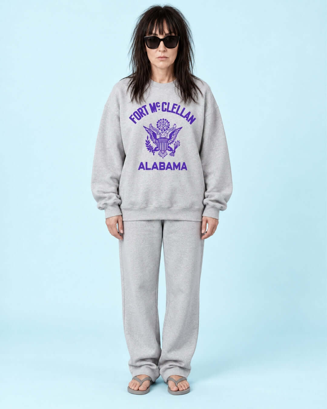 Helga wearing the Athletic Heather BINKY Fort McClellan Heavy Sweater with purple front graphic