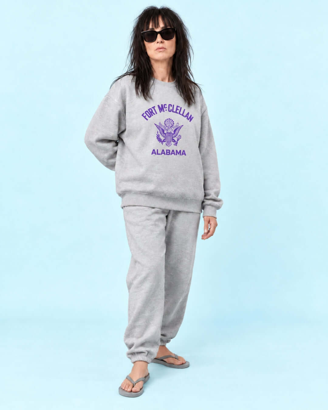 Helga wearing the Athletic Heather BINKY Fort McClellan Heavy Sweater with purple front graphic