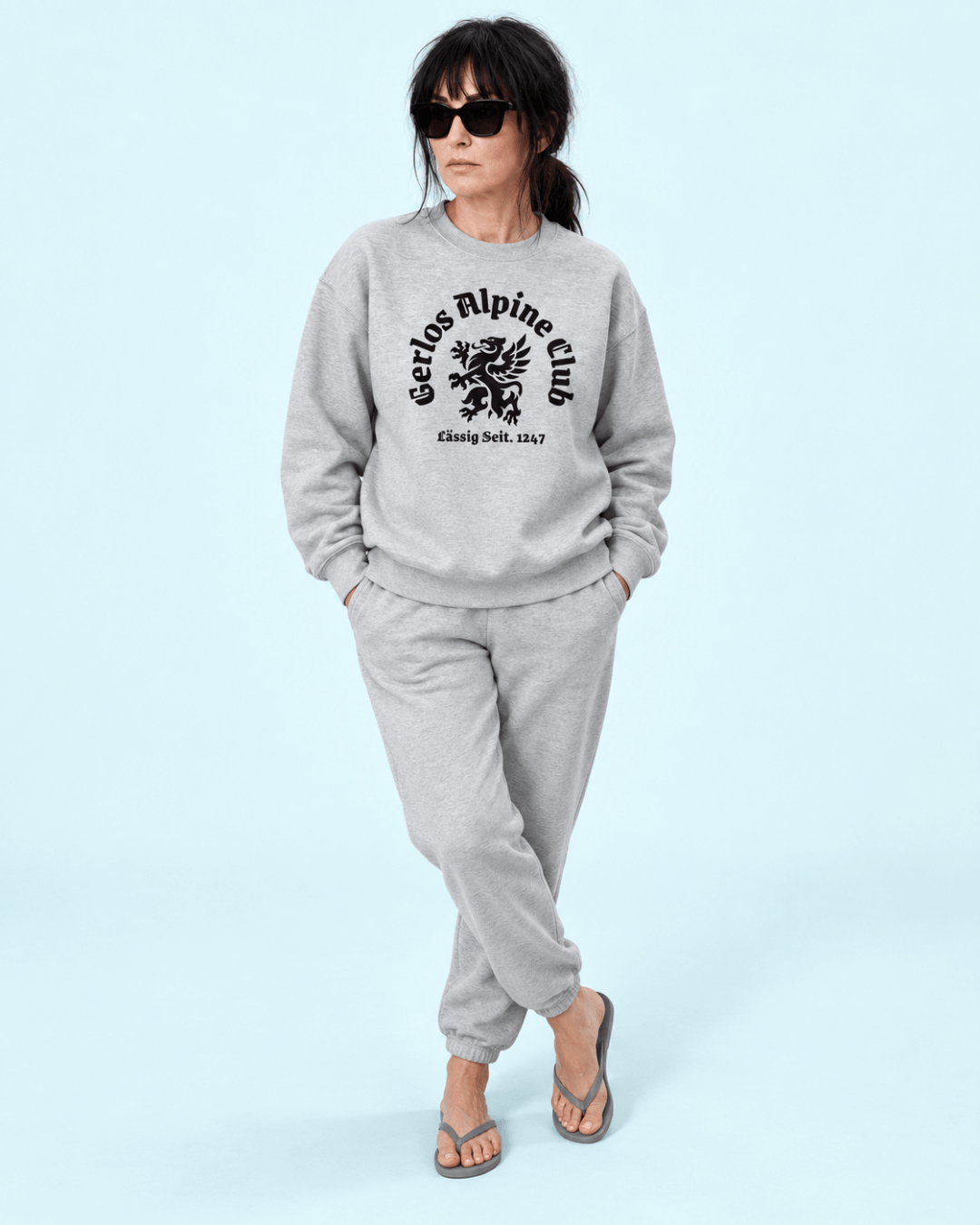 Gerlos Alpine Club Heavy Sweater worn by a woman in grey outfit, showcasing après-ski style.