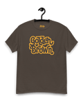 GOLDEN BROWN T-SHIRT | THE ULTIMATE GOLDEN HOUR displayed on a hanger, showcasing its vintage-inspired design.