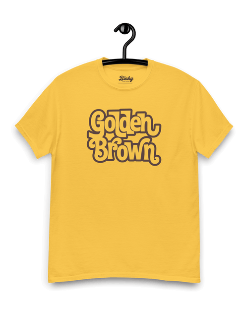 GOLDEN BROWN T-SHIRT | THE ULTIMATE GOLDEN HOUR displayed on a hanger, showcasing its unique vintage design.