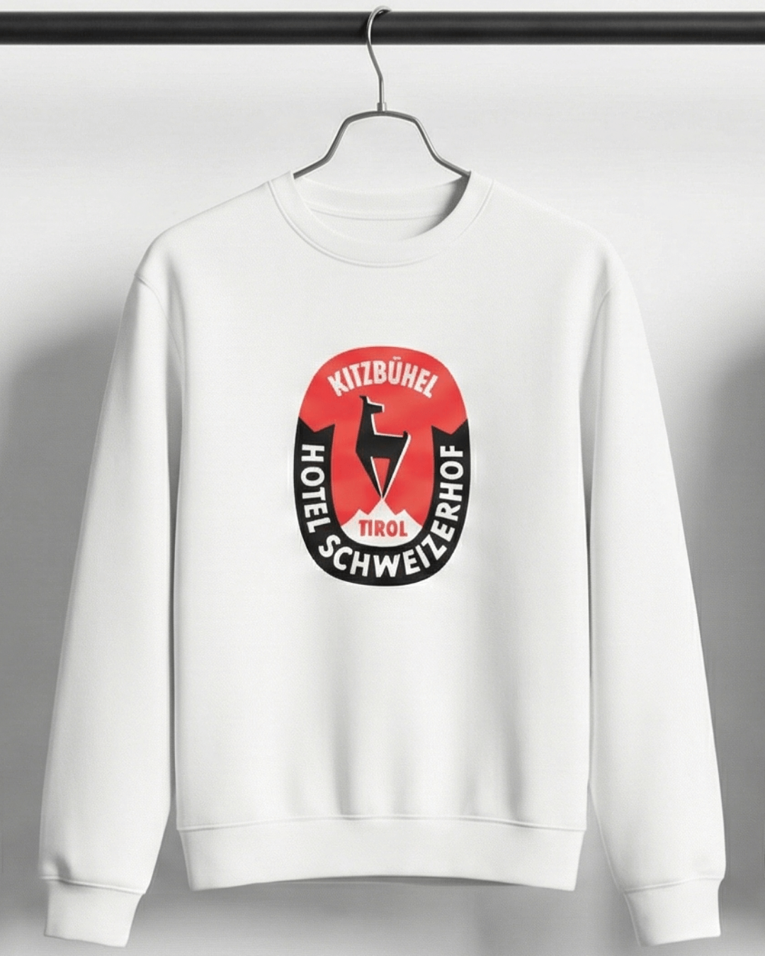 HOTEL KITZBÜHEL HEAVY SWEATER featuring vintage hotel crest on a white background.