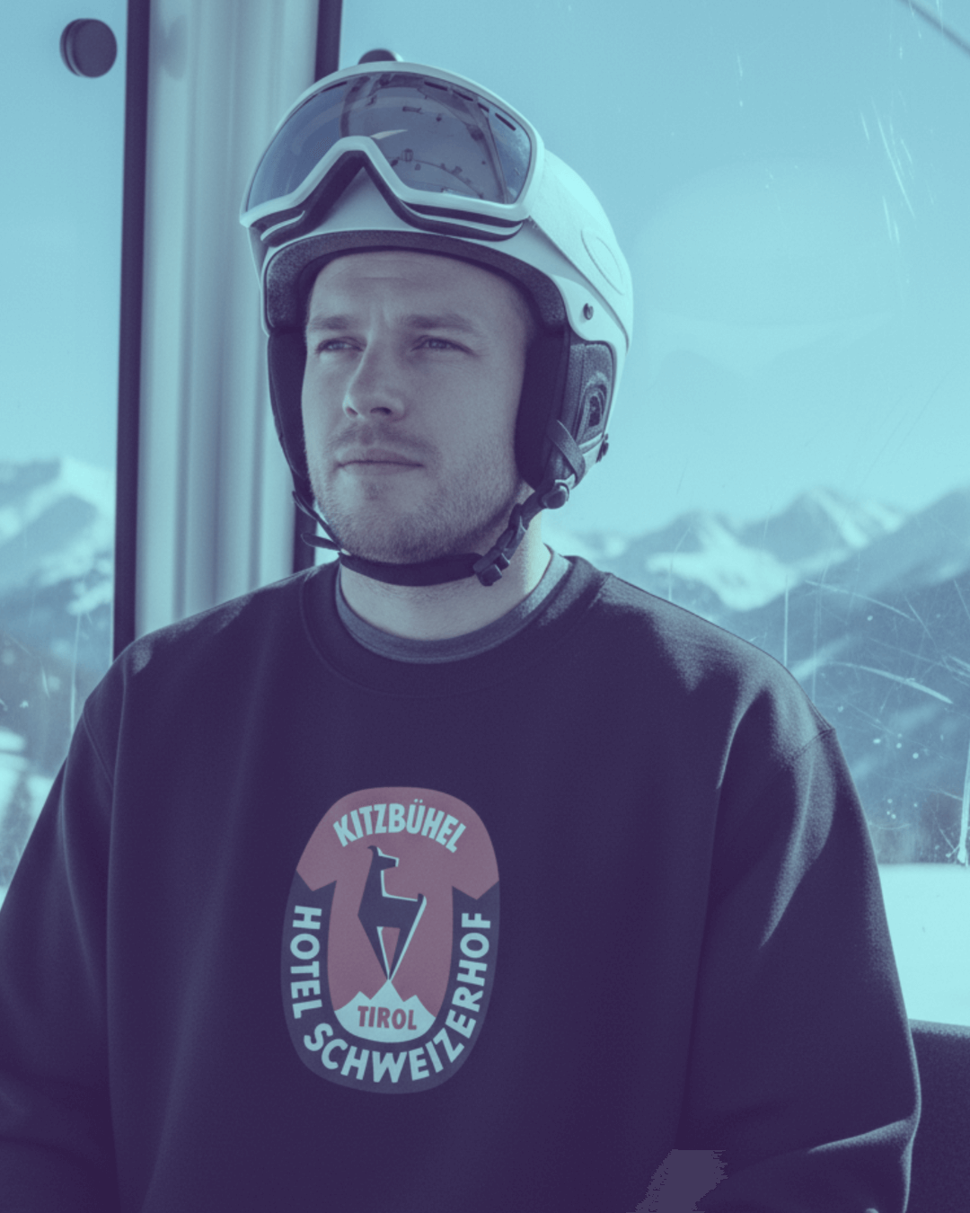 Man wearing HOTEL KITZBÜHEL HEAVY SWEATER with a ski helmet in a mountain gondola.