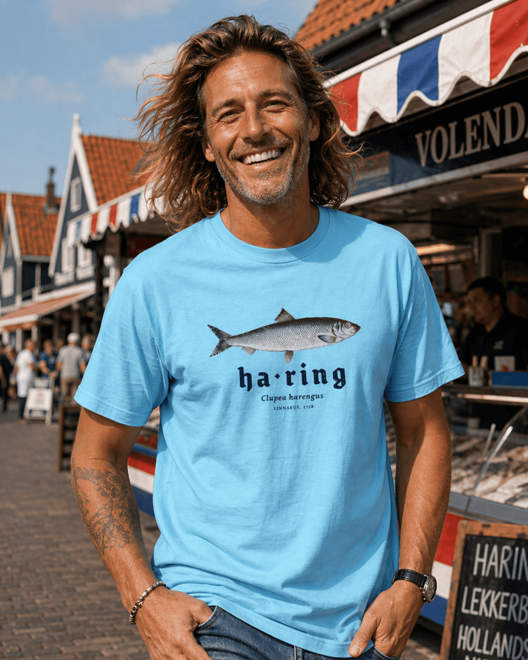 HERRING T-SHIRT | DUTCH CLASSIC RAW model wearing a blue T-shirt featuring herring design at a traditional market
