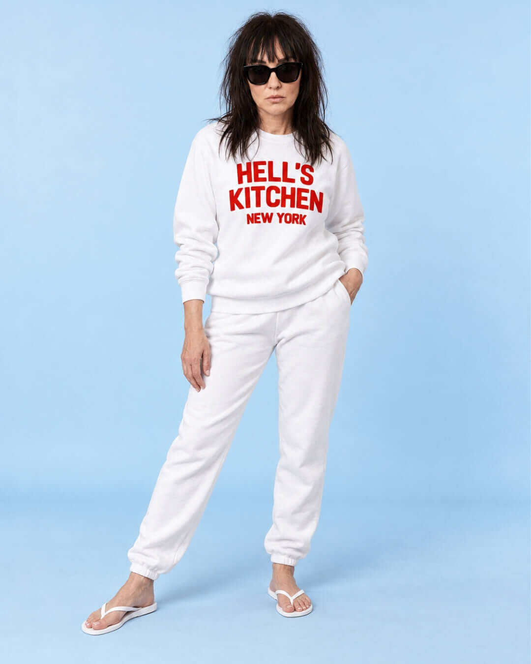 Helga wearing the White Hell's Kitchen NY Soft Sweater with red lettering and white joggers