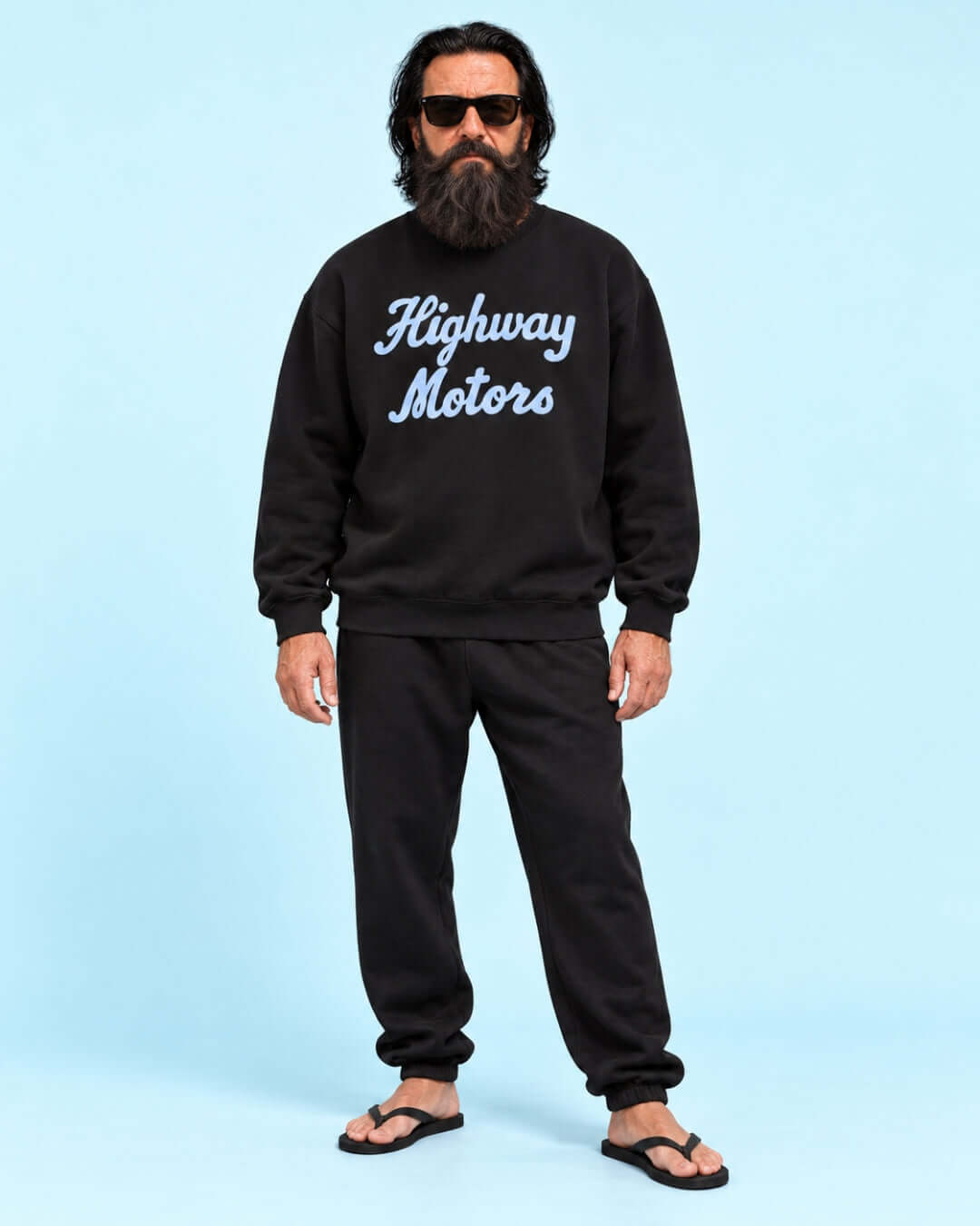 Walter wearing the black BINKY Highway Motors Heavy Sweater with light blue script graphic