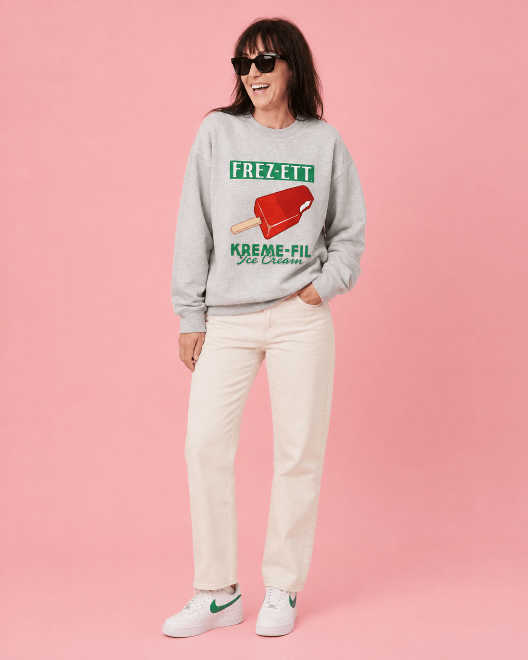 Model wearing Ice Cream Heavy Sweater with a pink background, showcasing vintage ice cream graphics.