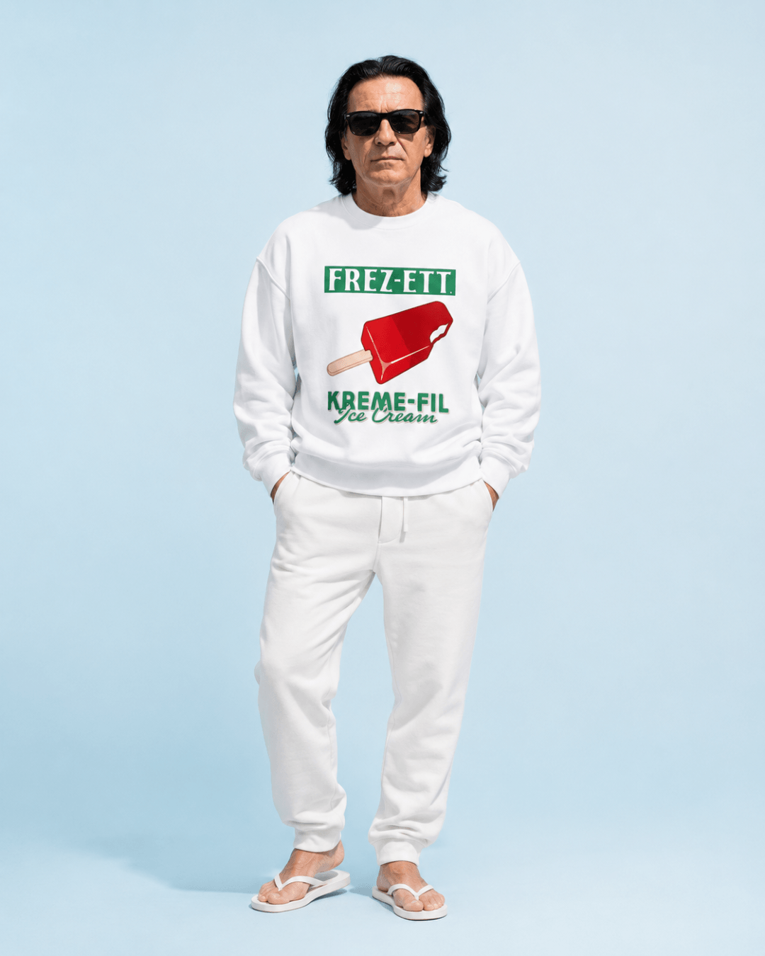 Man wearing Ice Cream Heavy Sweater with red ice cream graphic, posing against a light blue background.