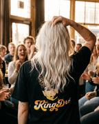 King Dre T-Shirt | Koning van het Levenslied worn by a person in a lively crowd, showcasing the cultural heritage of music.