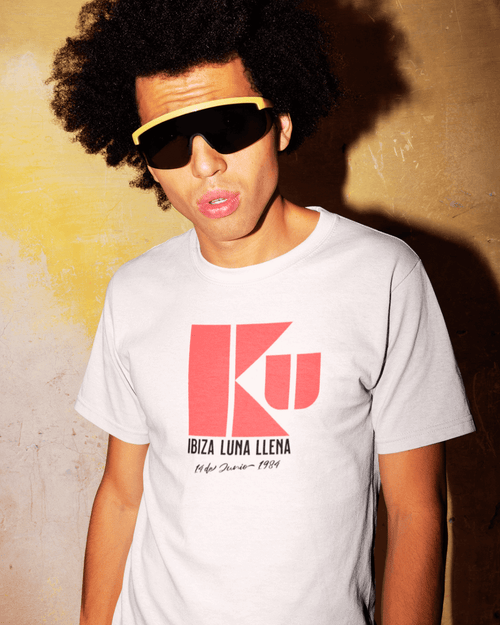 Model wearing KU IBIZA T-SHIRT with bold red graphic design, showcasing 80's nightlife style on premium cotton.