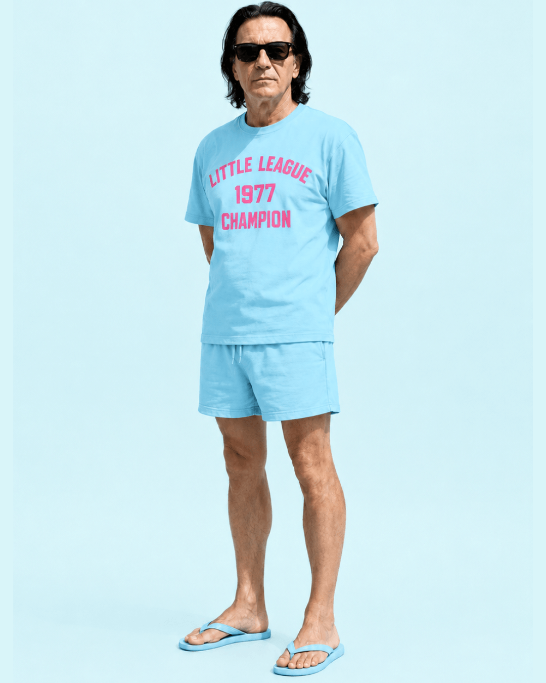 Model wearing a Summer League 1977 T-Shirt and matching shorts, showcasing vintage championship style.