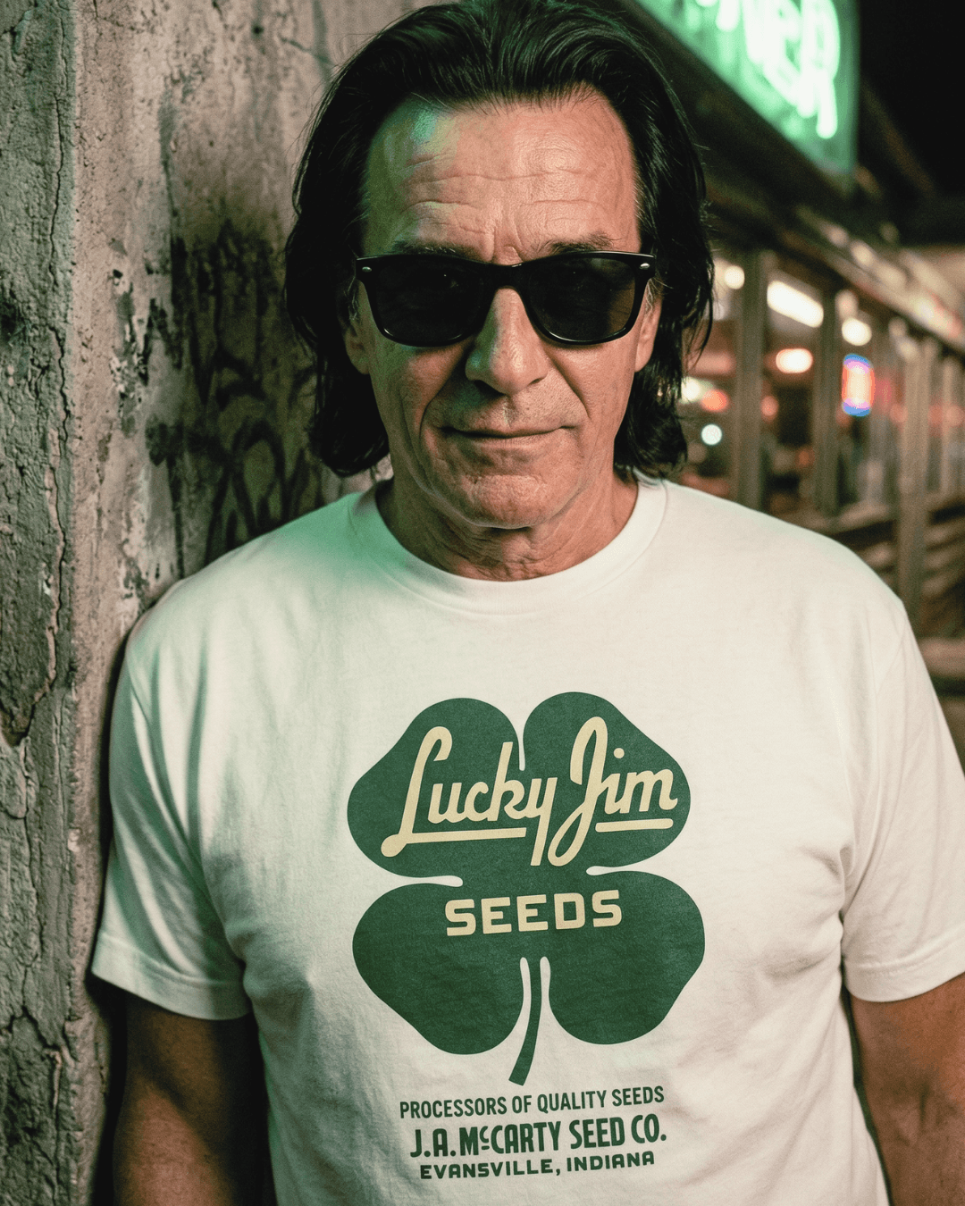 Person wearing a LUCKY JIM SEEDS T-SHIRT | HERITAGE WORKWEAR, showcasing vintage seed company graphic.