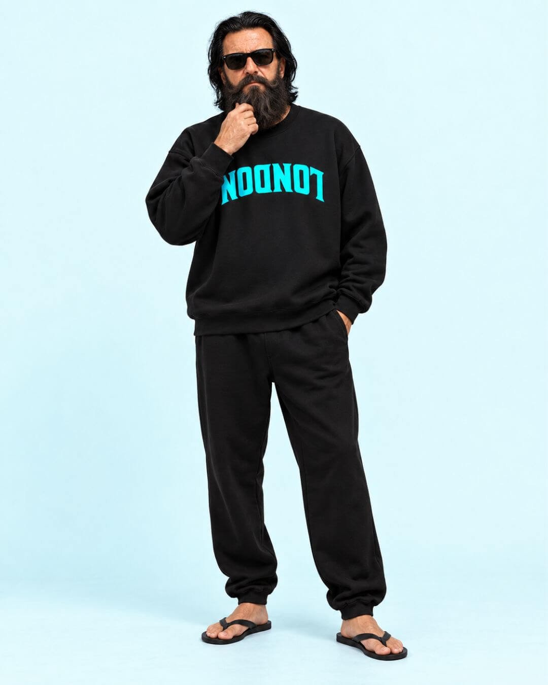 Walter wearing the BINKY COMFYWEAR London Heavy Sweater in Black with cyan inverted LONDON graphic.