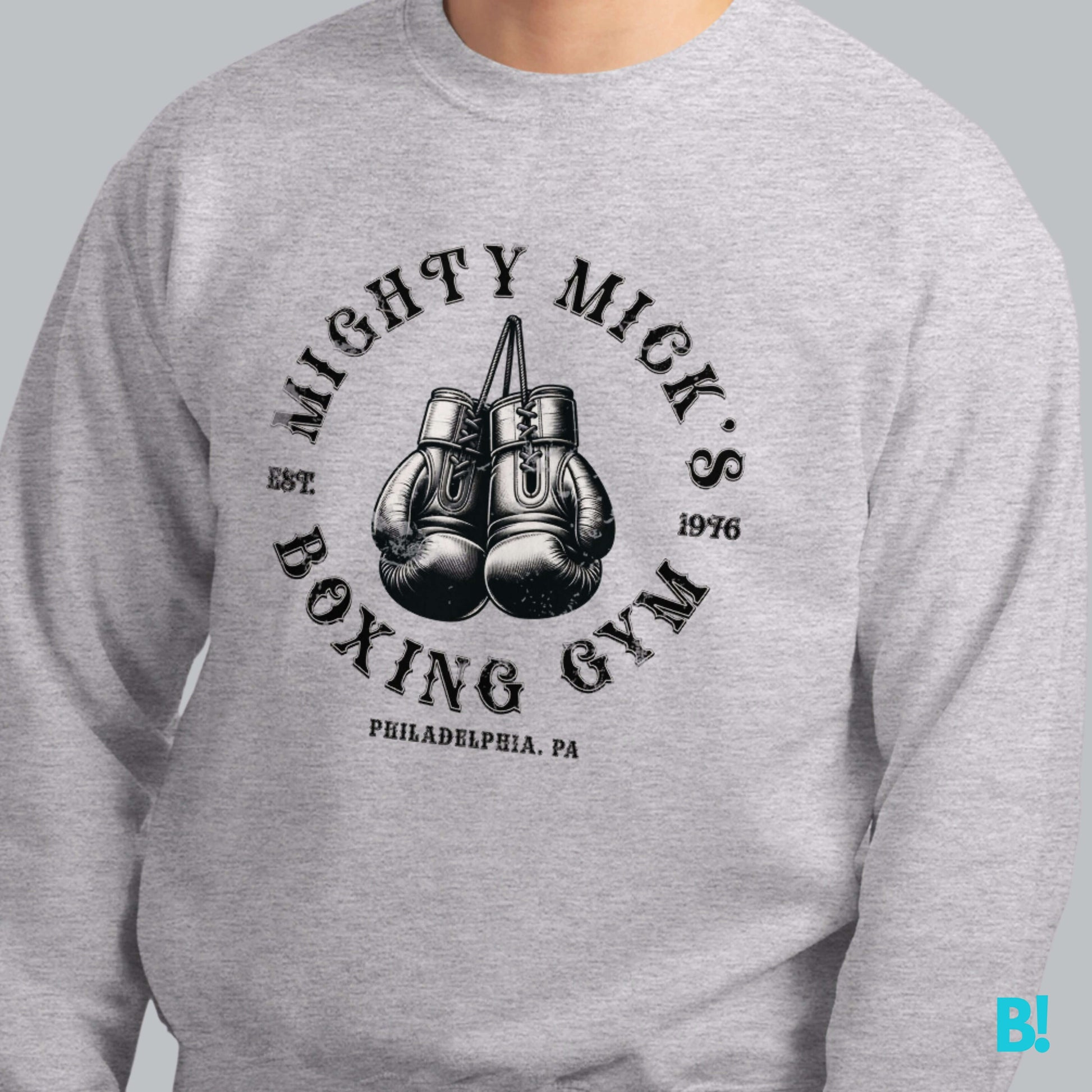 Grey Mighty Mick's Boxing Gym sweater featuring vintage boxing gloves design, inspired by Rocky. Perfect for sports fans and casual wear.