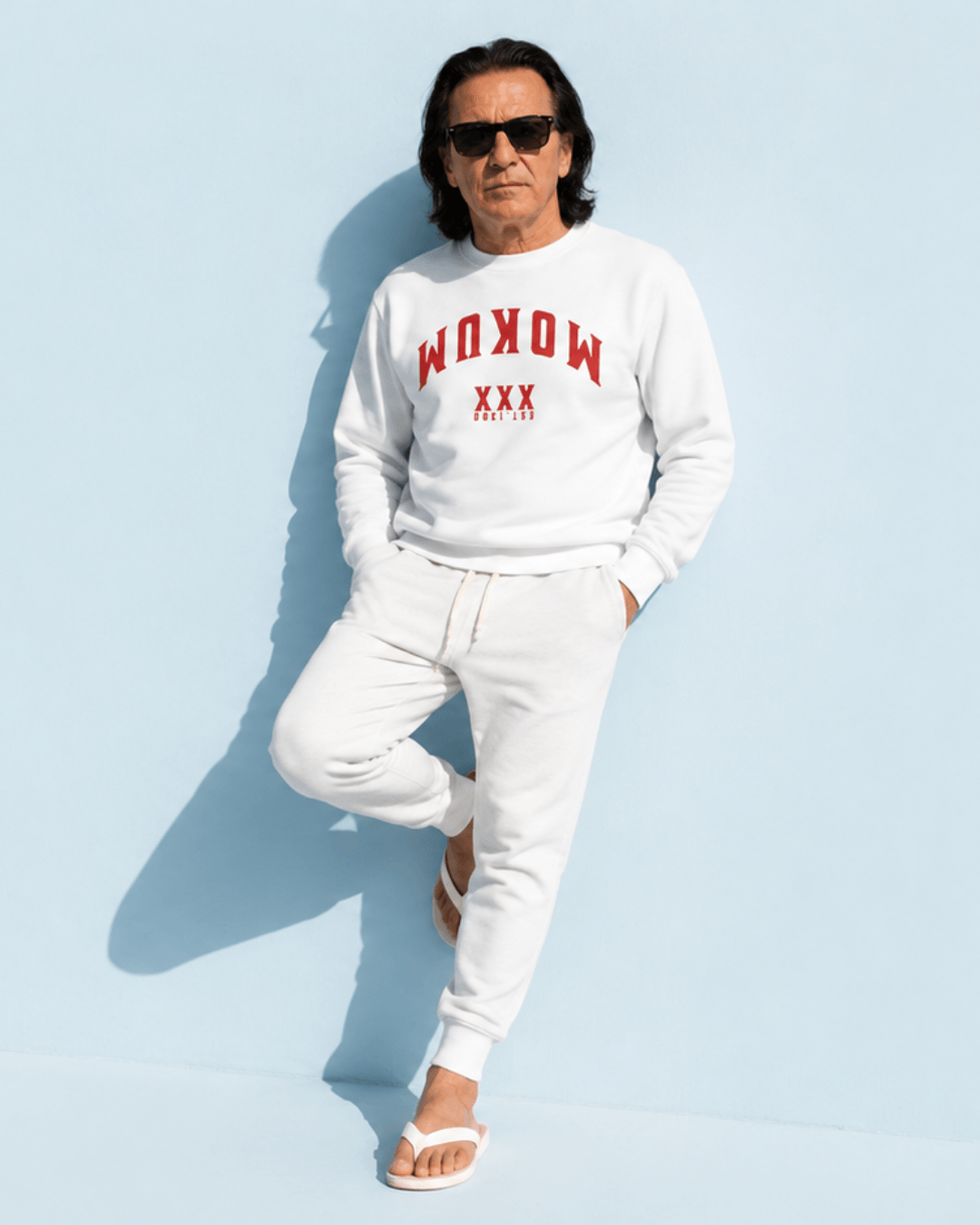 Amsterdam Sweater | Mokum Est 1300 Edition worn by a man outdoors against a light blue background.